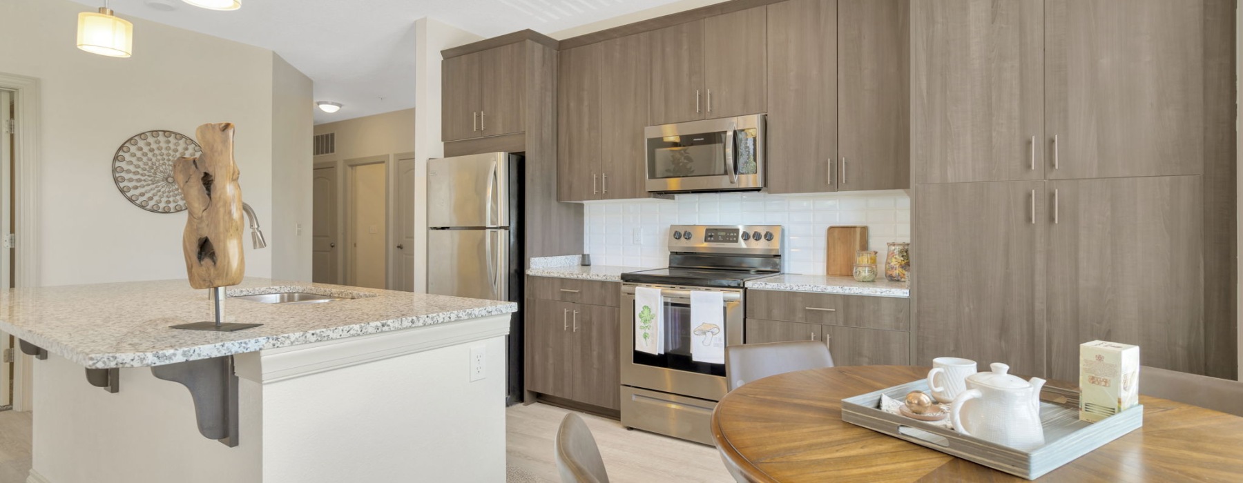 Kitchen with island overlooking living room with big window