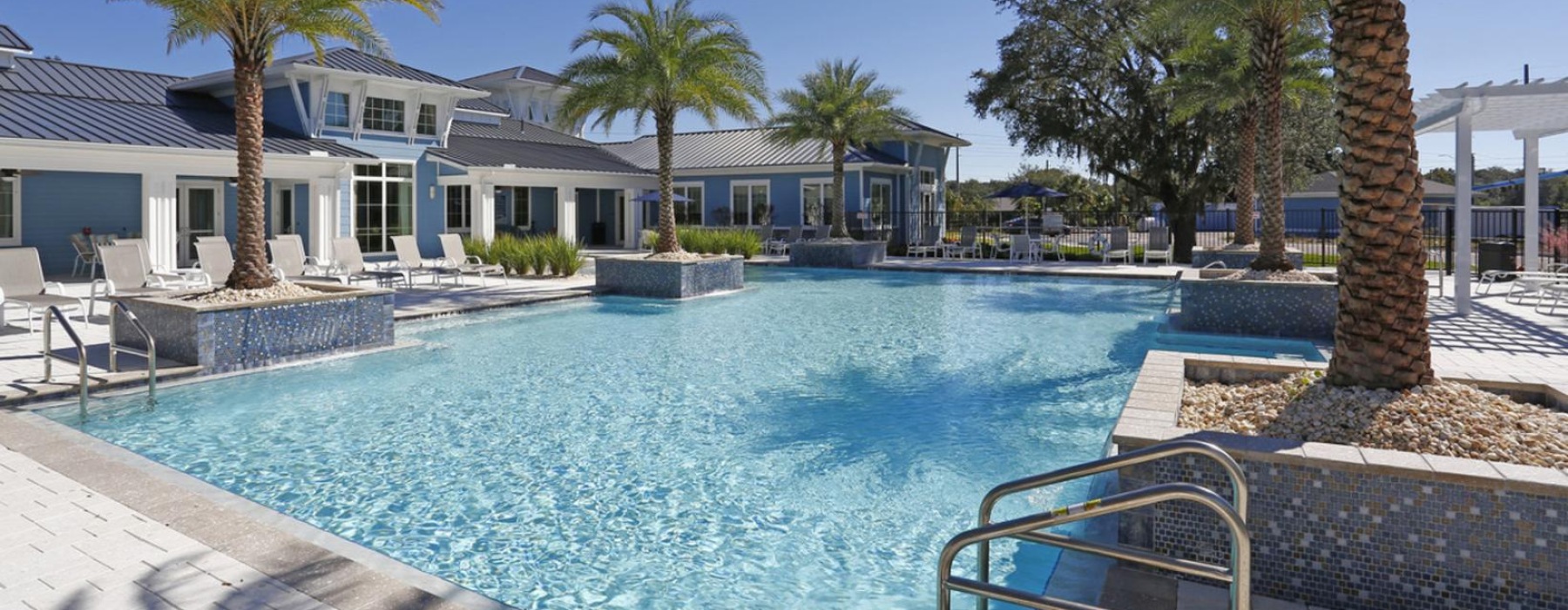 a pool with palm trees around it
