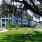 Mystic Pointe Apartments with on-property pond and picnic table under a large tree
