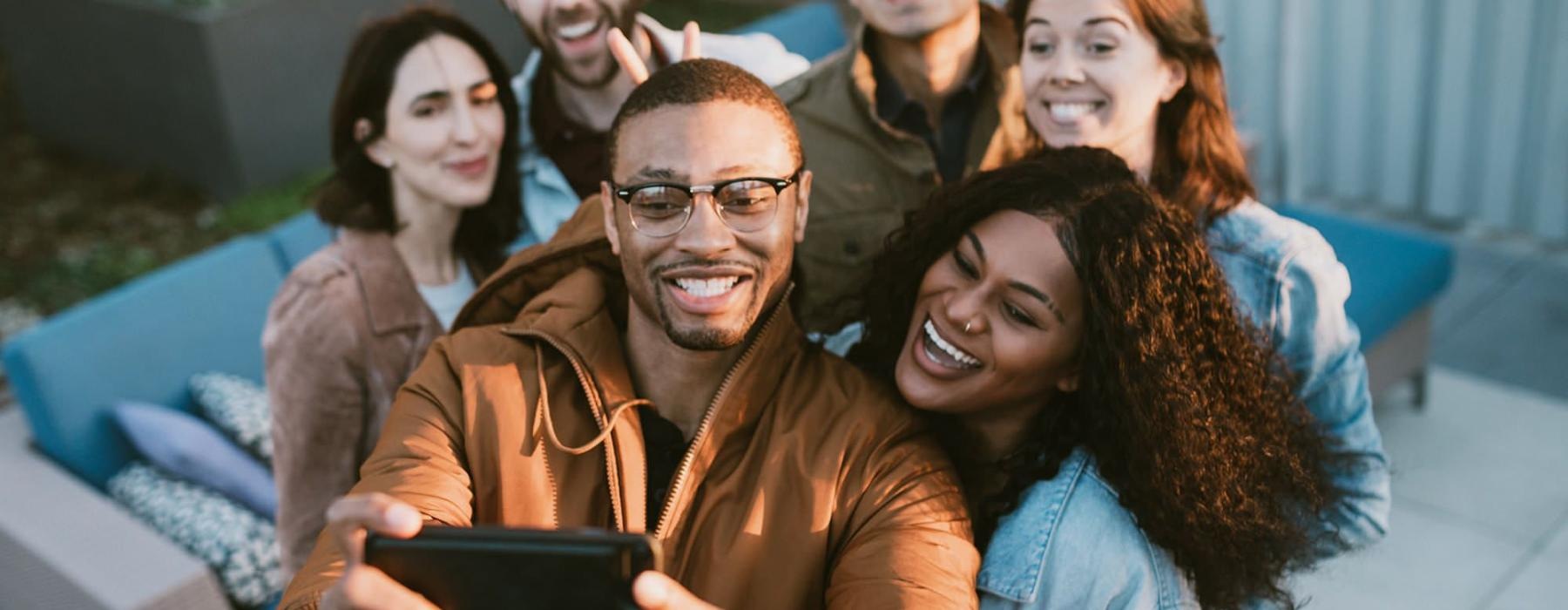 friends take a group selfie outdoors