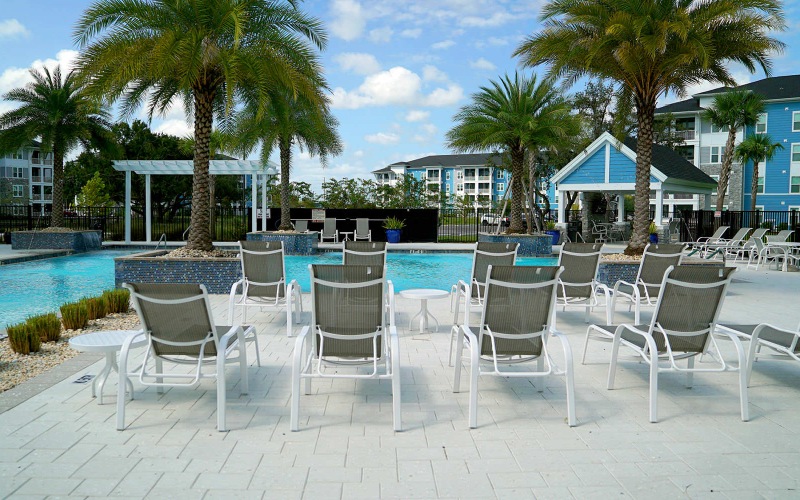lounge chairs next to outdoor pool